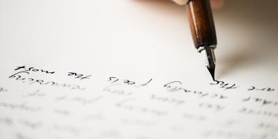 closeup view of a pen writing on a paper